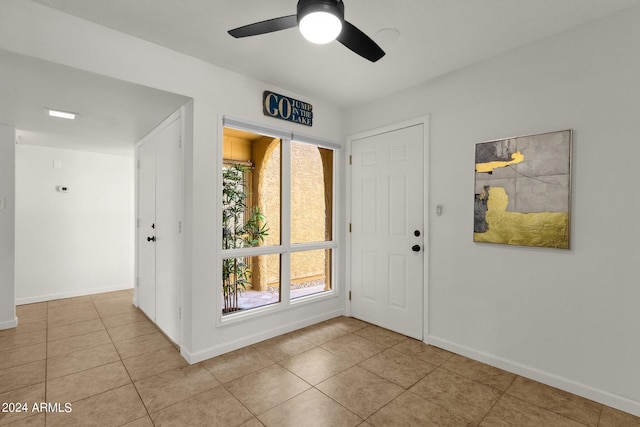 foyer featuring ceiling fan and light tile patterned flooring