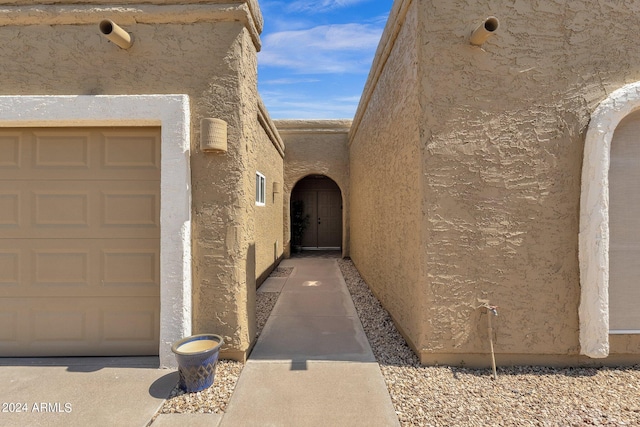 view of exterior entry featuring a garage