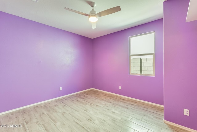 unfurnished room with ceiling fan, baseboards, and wood finished floors