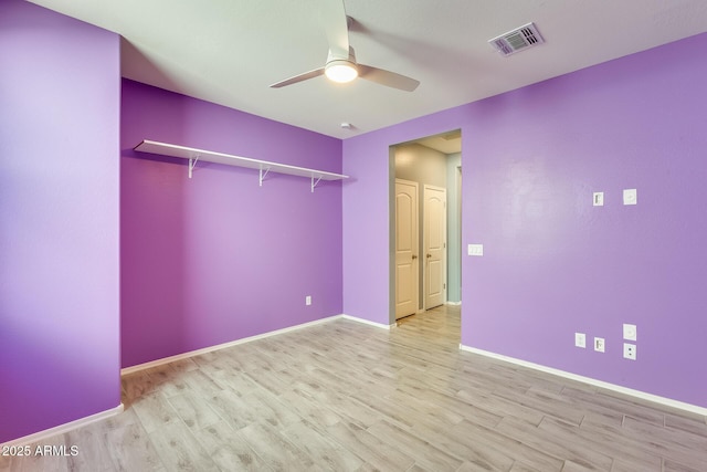 unfurnished bedroom featuring a ceiling fan, light wood-style flooring, visible vents, and baseboards