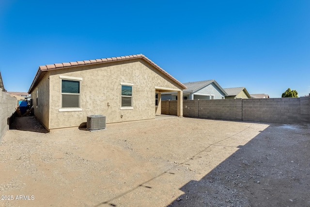 back of property featuring central AC unit, a patio area, a fenced backyard, and stucco siding