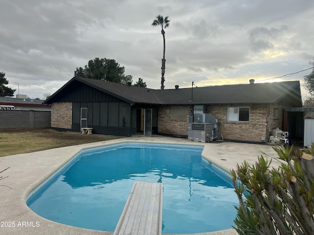 view of swimming pool featuring a grill, fence, a fenced in pool, and a patio