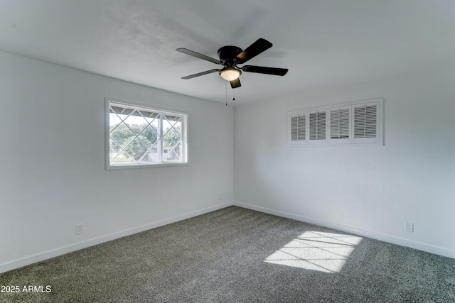 carpeted empty room featuring visible vents, ceiling fan, and baseboards