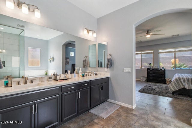 bathroom with oversized vanity, ceiling fan, dual sinks, and tile flooring