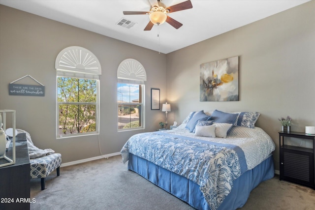 bedroom featuring light colored carpet and ceiling fan