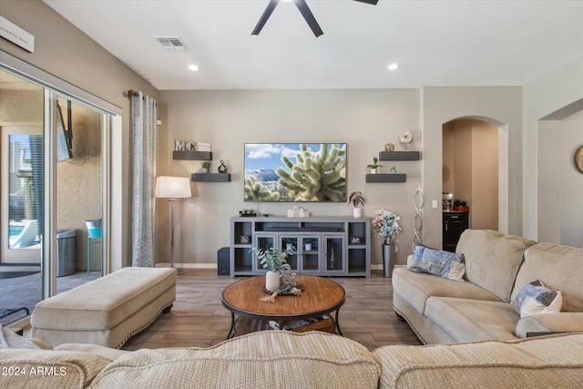 living room with ceiling fan and hardwood / wood-style flooring