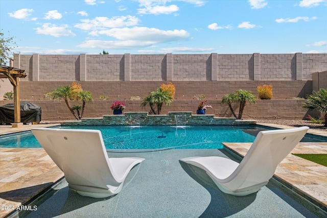 view of swimming pool with pool water feature