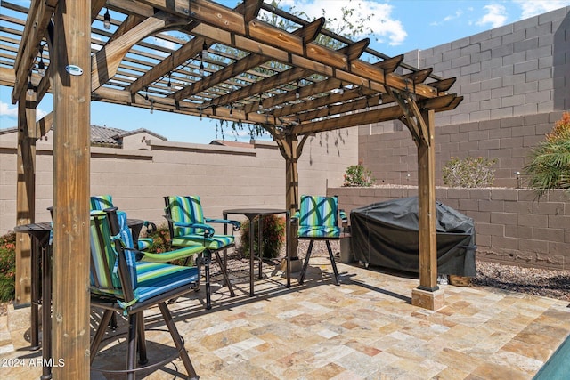 view of terrace with a grill and a pergola