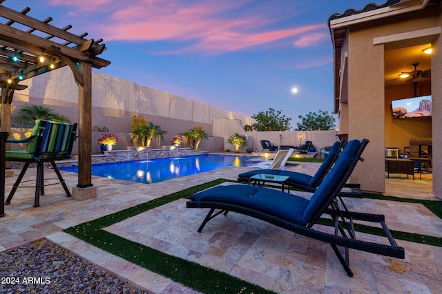 pool at dusk with a patio and a pergola