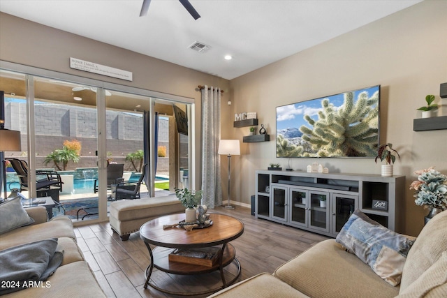 living room with light hardwood / wood-style floors and ceiling fan