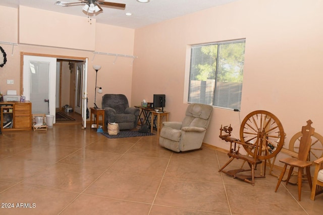 sitting room with tile patterned floors and ceiling fan