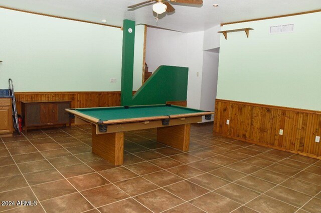 rec room with ceiling fan, wood walls, and billiards