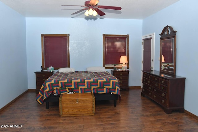 bedroom with ceiling fan and dark wood-type flooring