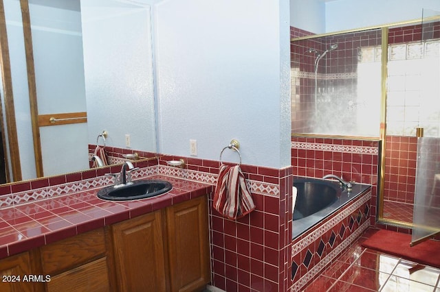 bathroom with tile patterned floors, vanity, and shower with separate bathtub