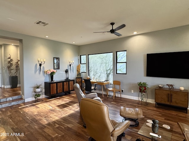 living room featuring hardwood / wood-style floors and ceiling fan