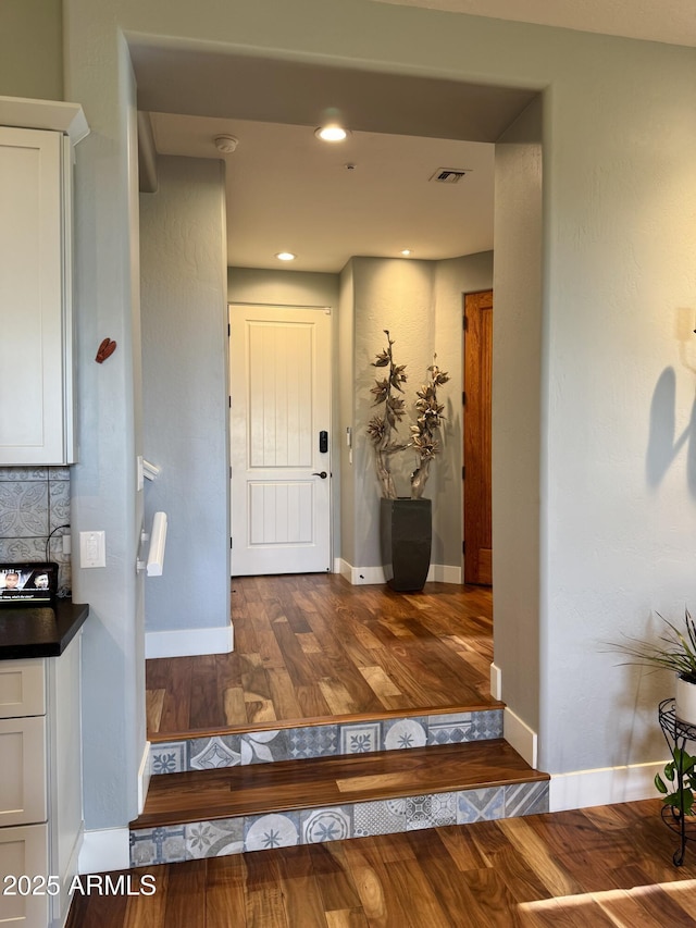 foyer entrance featuring dark wood-type flooring