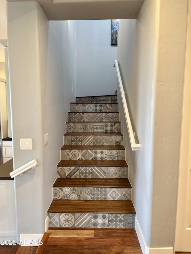 stairs featuring hardwood / wood-style floors