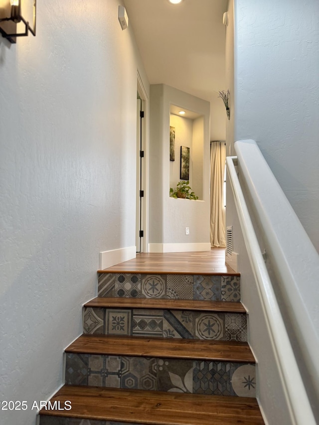 stairway featuring wood-type flooring