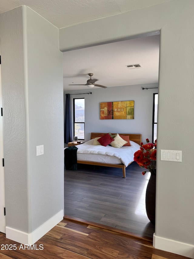 bedroom with hardwood / wood-style flooring and ceiling fan