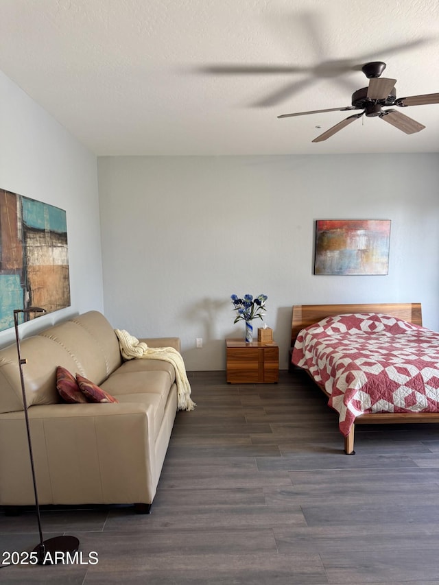 bedroom with ceiling fan, dark hardwood / wood-style flooring, and a textured ceiling