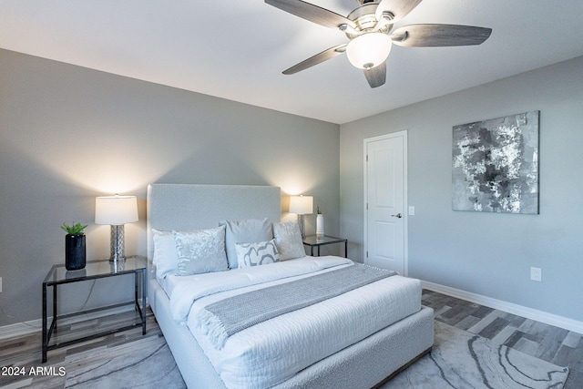 bedroom with wood-type flooring and ceiling fan