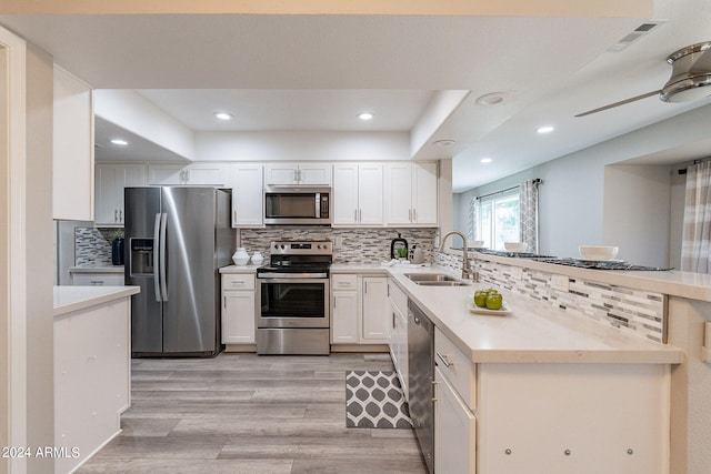 kitchen featuring light hardwood / wood-style flooring, stainless steel appliances, sink, and white cabinetry