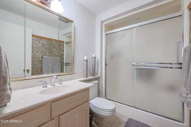 bathroom with vanity, an enclosed shower, tile patterned floors, and toilet