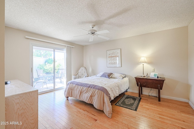 bedroom featuring ceiling fan, access to outside, a textured ceiling, and light wood-type flooring