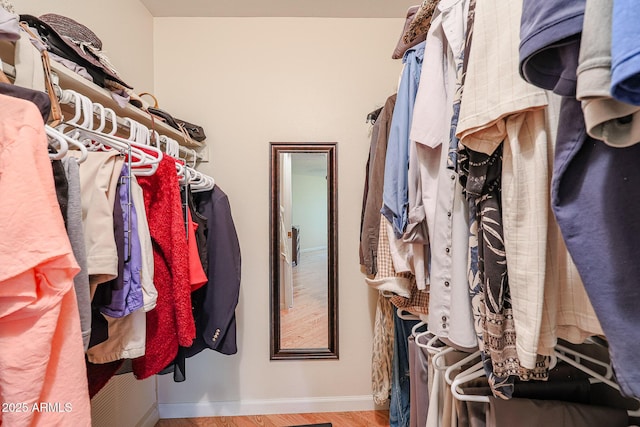 walk in closet featuring light hardwood / wood-style flooring