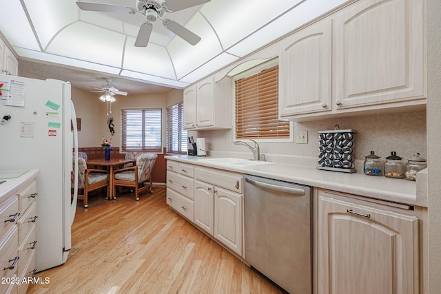 kitchen featuring dishwasher, sink, white refrigerator, ceiling fan, and light hardwood / wood-style floors