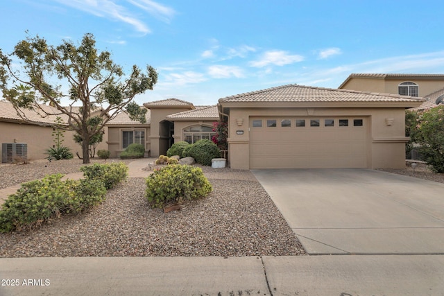 view of front of house with stucco siding, central air condition unit, concrete driveway, and an attached garage