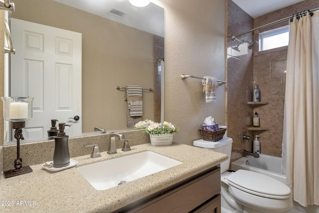 bathroom featuring visible vents, toilet, shower / bath combo, a textured wall, and vanity