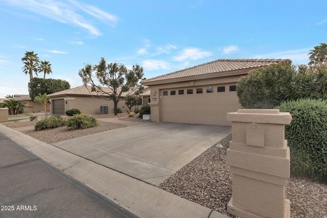 view of front of home with a tiled roof, a garage, and stucco siding