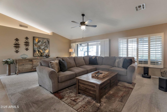 living room featuring visible vents, baseboards, a ceiling fan, and vaulted ceiling