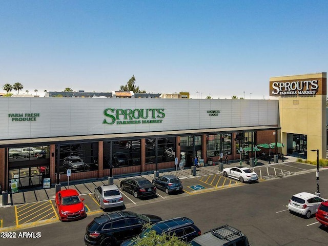 view of building exterior with uncovered parking