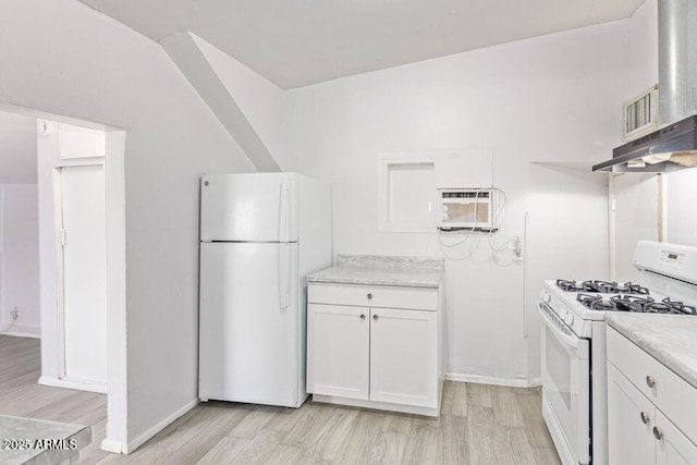 kitchen with a wall unit AC, white appliances, white cabinetry, and wall chimney range hood