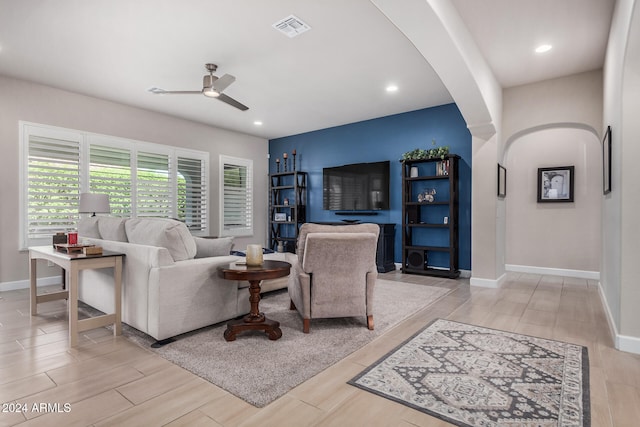 living room featuring ceiling fan and light wood-type flooring