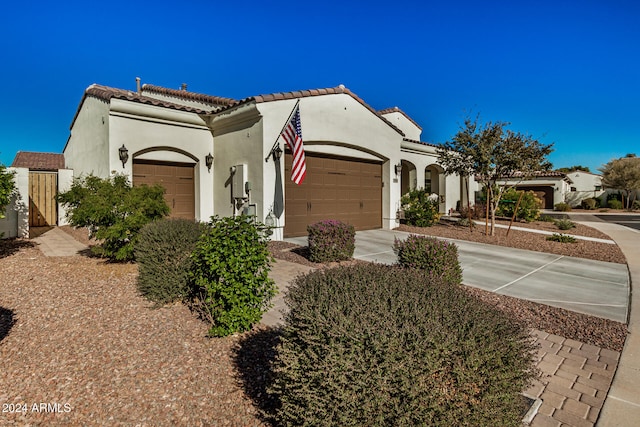 mediterranean / spanish-style home with a garage