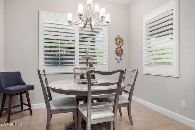 dining space featuring a wealth of natural light, light tile patterned floors, and a notable chandelier