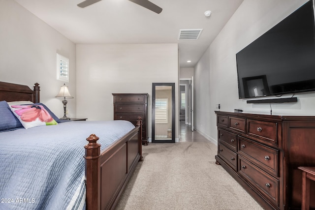 bedroom featuring ceiling fan and light carpet