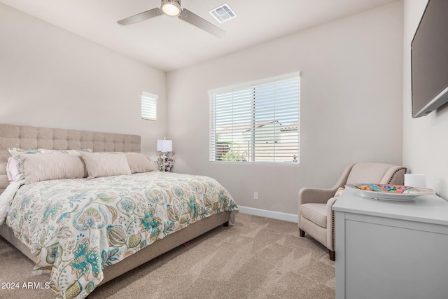 bedroom with ceiling fan and light colored carpet