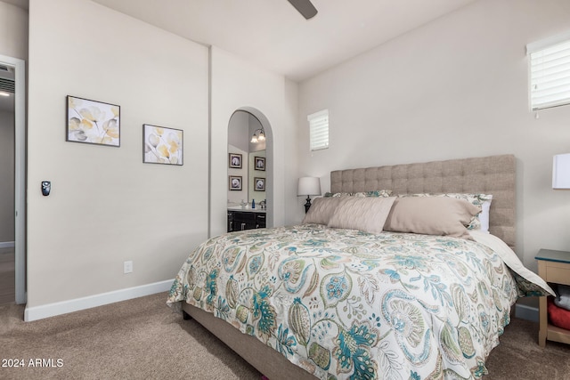 bedroom featuring carpet flooring, ceiling fan, and connected bathroom