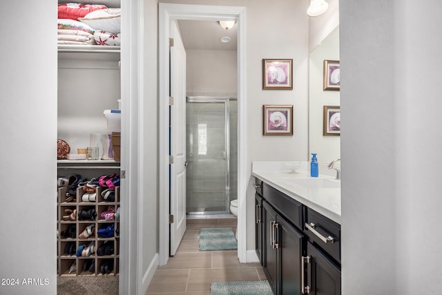 bathroom with vanity, toilet, and walk in shower