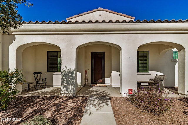 view of exterior entry featuring a patio