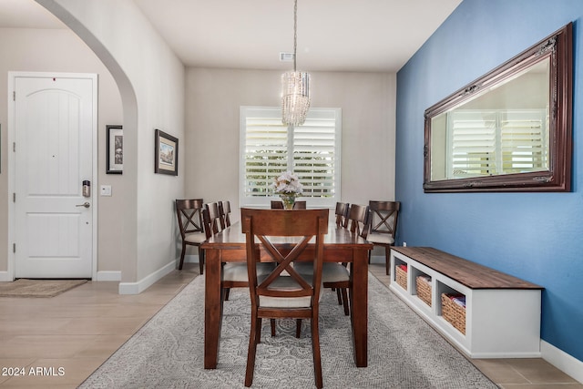 dining space with plenty of natural light and a notable chandelier