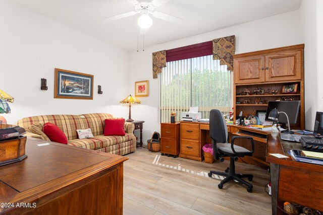 office featuring light hardwood / wood-style floors and a notable chandelier