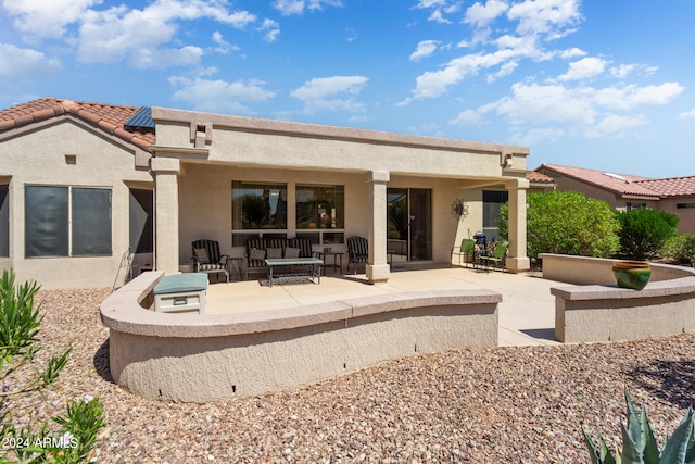 back of house featuring a patio area and an outdoor hangout area