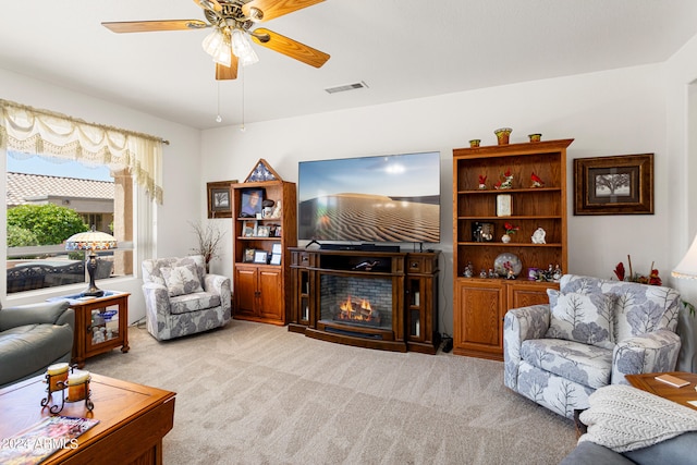 living room featuring light carpet and ceiling fan