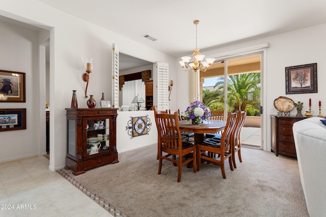 carpeted dining space featuring a notable chandelier