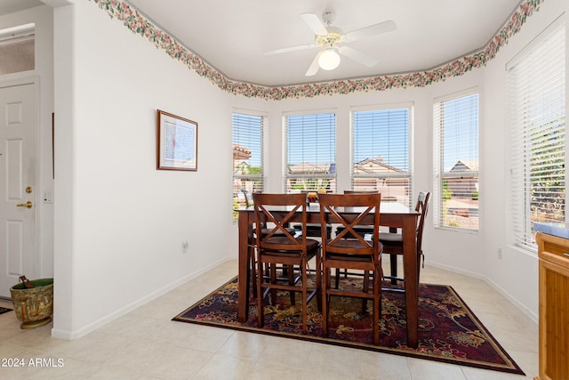 tiled dining space with ceiling fan